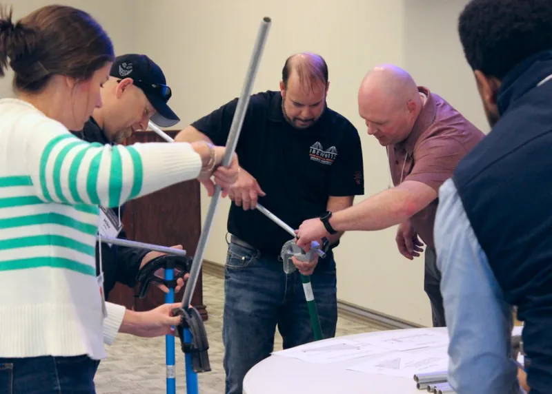 Educators bending conduit at the Boardman, Oregon workshop